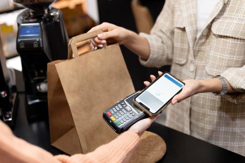 Paying with a phone at a shop counter